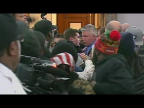 Cops, citizens scuffle at St. Louis meeting