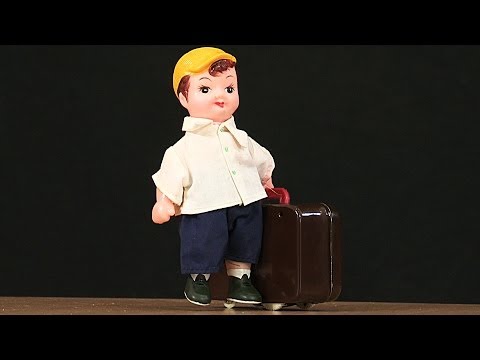 Plane - This wind up toy comes from China, and it was made in the 1980s. The man has a big suitcase, and appears to be in a hurry. We think he is running for the pla...