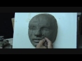 Sculpting a female face in clay