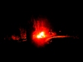 Shooting a spary paint can next to a fire.