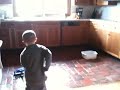 Morgan mops the kitchen floor