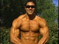 Bodybuilder Jaime Davila posing at a park 2