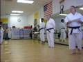 Steven receiving his promotion to green belt.
