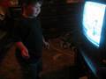 Boy dances to Happy Feet menu screen