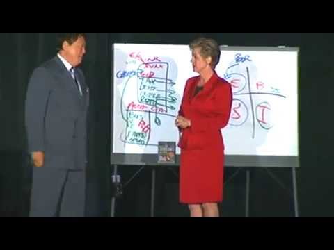 Erin Botsford presents on stage with Robert Kiyosaki at the “Rich Dad, Poor Dad” event in Dallas.