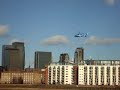 Helecopter takes off and flies over Canary Wharf in London