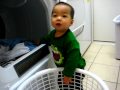 Peyton helps put the clothes in the dryer