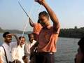 Village magician performing in a boat on a beautiful Kerala
