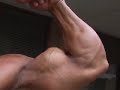 Bodybuilder Jerry Serna poses biceps outdoors