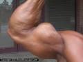 Bodybuilder Jerry Serna poses biceps outdoors