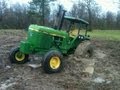 Excavator Pulls out Stuck Deere 4440 Tractor