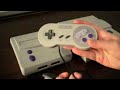 Classic Game Room presents a CGR Undertow video game console review of the SNS-101 Super Nintendo Entertainment System aka SNES 2, SNES Mini, or SNES Jr. Released in 1997 as a cheaper alternative to fifth generation consoles like the Sony PlayStation, Nintendo 64, or Sega Saturn, the SNS-101 was designed to be more compact and lightweight than the original Super Nintendo. There's also a few minor differences in its power and reset buttons and video output as pointed out in this video, but otherwise this miniature version of the classic gaming system is great as a replacement for a broken console or for die hard collectors. This review demonstrates the SNS-101 with commentary from CGR Undertow reviewer Kevin.