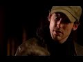 a dvd pirate sells his wares to a group of mates in a pub. they ask him for 