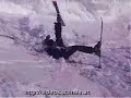 SKIER JUMPING UPHILL OVER CORNICE SKIER JUMPING UPHILL OVER CORNICE
