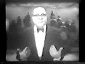 allan sherman has a bunch of people standing behind him.