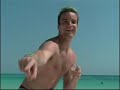 Paukie walking on a beach on Aruba looking like David Hasselhof