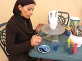 Pottery painting artist in Taormina demonstrates her craft