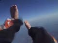 Jet flying under Skydivers