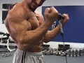 Bodybuilder Craig Torres biceps curl and pose