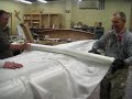 During this session of our canoe class we fiberglassed the outside of the 16' lake canoe. The process involves sanding the outside smooth, and then cutting two layers of 6oz woven fiberglass to fit the outside. We then apply a generous coating of resin through the fiberglass cloth. When cured the final product is hard as a rock and extremely strong. www.WoodZone.com