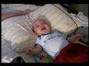 Ayden laughing at my flapping my laundry.
