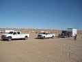 Chevy 2500HD & Ford F350 pull dump truck w/ stacker trailer out of sand.