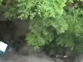 throwing a giant water balloon off a roof onto a port a pott
