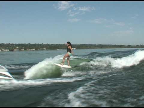 Rayne riding behind a Centurion on Inland Surfer Infectious board