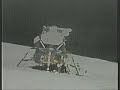 Moon Landing Hoax Apollo 16 : Two Stagehands Are Seen in The Fake Moon Bay Next To An Astronaut