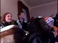 Watching the Super Bowl at a friend's house, an excited fan throws a football through the Tv