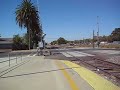 Amtrak San Joaquin #714 departs one grade crossing then stop