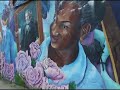 When this mural was executed, 20 years ago, the Pullman neighborhood was predominantly white and neighboring Roseland was predominantly African-American. Artist Olivia Gude created this mural to show the bonds between the two communities. The mural is on a Metra underpass at 113th St and Cottage Grove Ave.