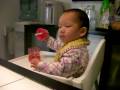 Baby Natalie chatting and playing in her highchair
