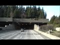 (Driving across in semi Mack Truck) Driving across Lake Washington from Bellevue to Seattle through Mercer Island Tunnel on I-90 Floating Bridge and through Mount Baker Tunnel. The I-90, Lacey V. Murrow Memorial Bridge is a floating bridge that carries the eastbound lanes of Interstate 90 across Lake Washington from Seattle to Mercer Island, Washington. It is the third longest floating bridge in the world at 6620 ft (2020 m). Opened July 2, 1940. It sank in a storm on November 25, 1990, while it was undergoing refurbishing & repair. The current bridge was built in 1993. The Mount Baker Tunnel or Mount Baker Ridge Tunnel carries Interstate 90 under the Mount Baker neighborhood of Seattle, Washington. It is actually a group of four tunnels that carry eight lanes of freeway traffic, plus a separate tunnel for bicycles and pedestrians. The two originals are twin tunnel bores completed in 1940 and rehabilitated in 1993. Two double-decked tunnels and the bicycle/pedestrian tunnel were built north of the original tunnels in 1991.The official length is 1440 feet.
