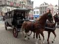 A wedding in Delft, Holland. The Bride & Groom are driven away in a horse-drawn carriage