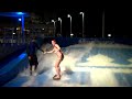 Cruise Critic Copy Editor Ashley goes surfing on Oasis of the Seas' FlowRider just after sundown.