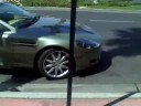 green aston martin DB9 accelerating and start up on el PAsEo