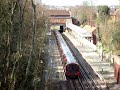 Central line tube train arriving and then leaving Chigwell
