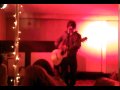 Belton playing acoustic