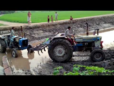 Tractorpulling - A tractor got stuuck in a canal due to hairo, Tractor 2 comes for rescue.