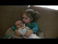 Big Sister Holds Baby Brother