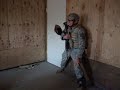 soldier from cco 1-24 25th id breeches a door with a running start.