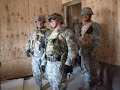 soldier from cco 1-24 25th id breeches a door with a running start.