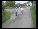 Daffodil and Mei Mei cycling up the Fort Augustus driveway (short)