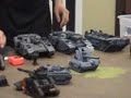 The Games Workshop store in Manchester England held the World Record for a Tank Battle at 1157 units -- they said it couldn't be beaten. They were taken to task at the Battle Bunker in Chicago. Disclaimer: If you are visually uneducated and don't understand what a competition is, or just have something negative to say you may certainly submit your comment -- and I will delete it time permitting. Video FAQ: 1. But some of the tanks/models weren't painted, did they count? Answer: Yes. There were incentives and bonuses awarded for tanks purchased within a certain time frame right up until noon that day. Some of the tanks were literally purchased and built that morning. 2. Walkers and Dreadnoughts and Titans aren't tanks did they count? Answer: Yes. Anything with an armor value counted 3. Why all the nationalism? Why chant USA? Answer: Because the Chicago Battle Bunker was going for the record which was previously held in Manchester, England. Two separate countries. It was a competition. I don't know how else to explain that. Plus, it was Veterens' Day. 4. Why all the fat people? Welcome to middle America -- the food's better here.