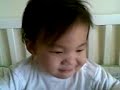 EJ in his cot - making faces