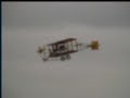 a replica curtiss pusher biplane goes thru its paces