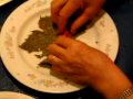 My Mom making Sarma (stuffed grape leaves)