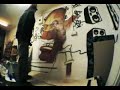 Graffiti artist, Rasty, paints a character in his studio.