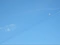 Chemtrail spraying across a shadowy black line.